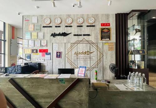 a restaurant with a counter with clocks on the wall at Aladdin Dream Hotel in Johor Bahru