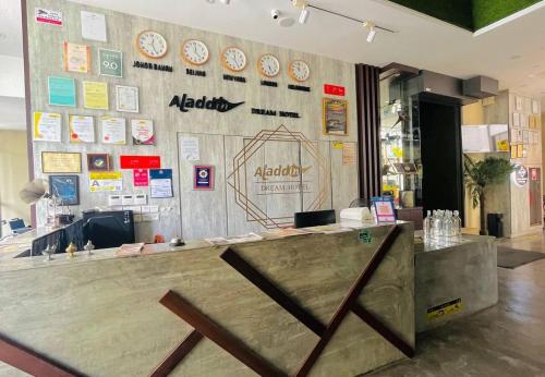 a restaurant with a counter with clocks on the wall at Aladdin Dream Hotel in Johor Bahru
