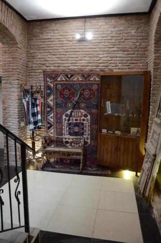 a room with a wall with a tapestry at Tiflis Hotel in Tbilisi City