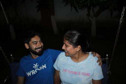 a man and a woman sitting on a swing at "Priyadarshi Villa" Free pickup in ac car from Jasidih Railway station or Deoghar Airport in Deoghar
