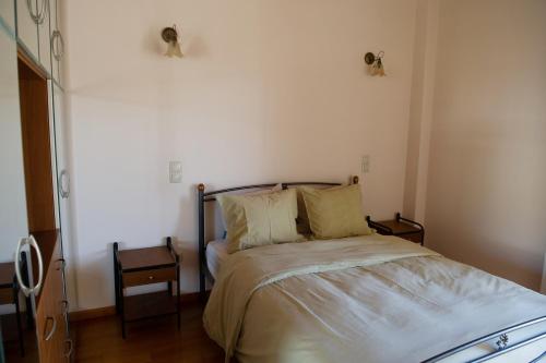 a bedroom with a bed and a table and a chair at Villa Pasithea in Korfos