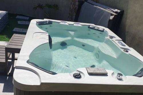 a large jacuzzi tub sitting on a patio at 5BR w/ Covered Pool, Jacuzzi, & Gazebo 