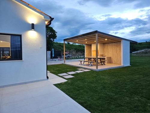 a pavilion with a picnic table in a yard at Villa Panorama in Buzet