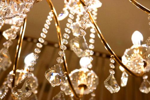a close up of a chandelier with crystals at The Ocean Hills 大東温泉 LIBERTY RESORT in Kakegawa