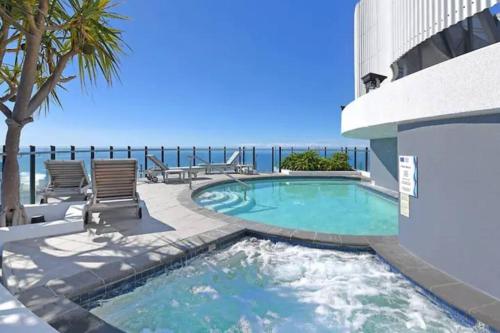 a swimming pool with the ocean in the background at Modern luxury with breathtaking ocean views in Gold Coast