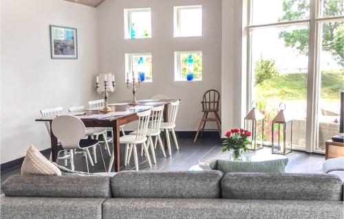 a living room with a couch and a table and chairs at Awesome Home In Trelleborg With House Sea View in Trelleborg