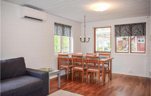 a dining room with a table and chairs and a couch at Awesome Home In Bolmsö With Wifi in Bolmsö