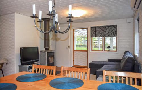 a living room with a couch and a table at Awesome Home In Bolmsö With Wifi in Bolmsö