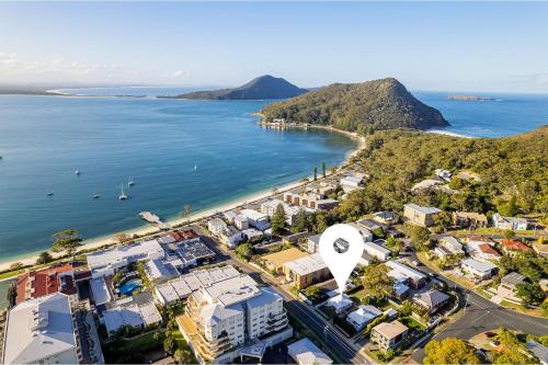 an aerial view of a city and the ocean at Tomaree Cottage 12 Tomaree Road - 200 mtrs to Beach - Pet Friendly, linen, WiFi & aircon in Shoal Bay