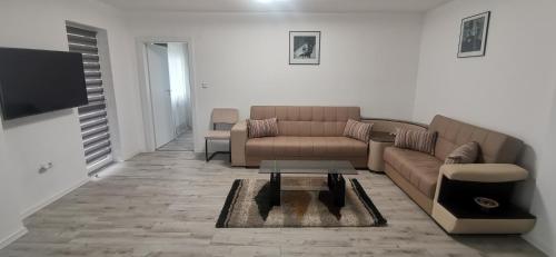 a living room with a couch and a table at Sweet Home in Miercurea-Ciuc