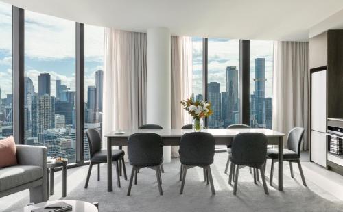 a dining room with a table and chairs at Oakwood Premier Melbourne in Melbourne