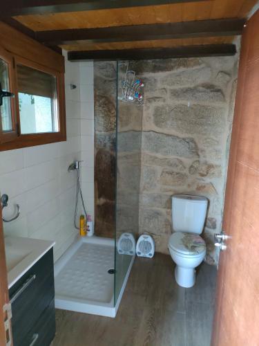 a bathroom with a glass shower and a toilet at CASA JS in Ourense