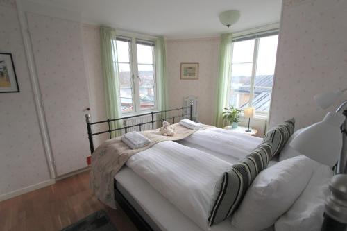 a bedroom with a bed with a cat sitting on it at Bed & Breakfast Villa Sedin in Härnösand