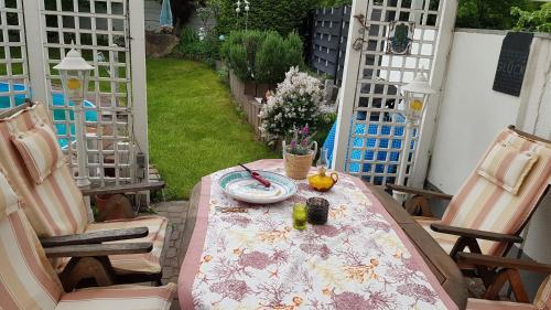 a table and chairs on a patio with a table at Ferienzimmer Bella Casa in Biebesheim