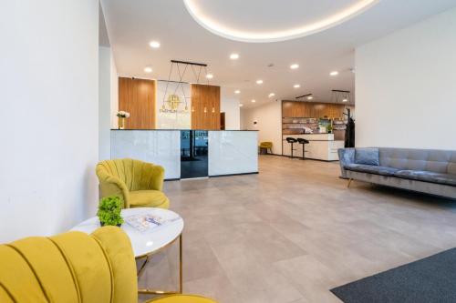 a living room with yellow chairs and a table at Premium Apartments in Budapest