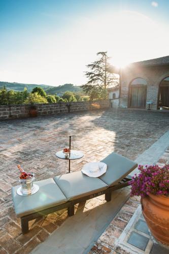 a patio with a table with two plates on it at Castello del Capitano delle Artiglierie in Castrocaro Terme