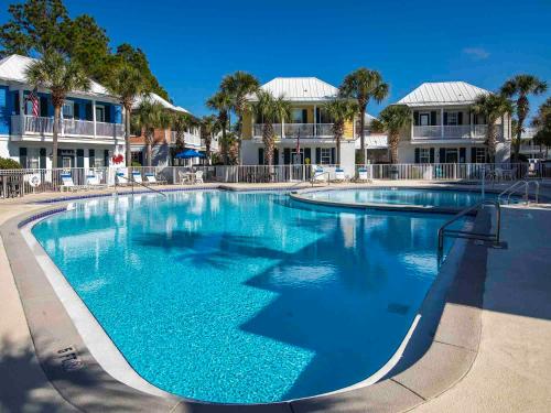 a large pool with blue water in a resort at Bungalows at Seagrove #149 - Three Little Birds Bungalow 30A in Seagrove Beach