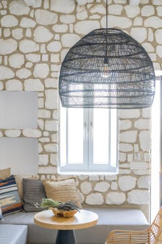 a pendant light hanging over a table in a living room at Euphoria Chora Naxos in Naxos Chora