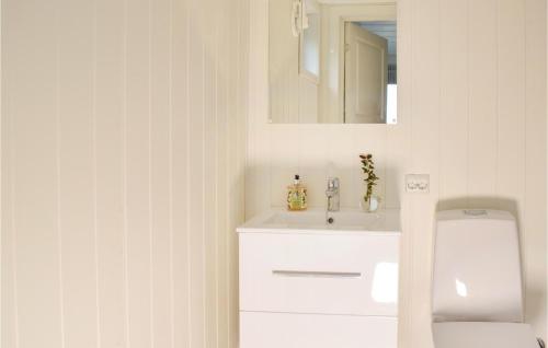 a white bathroom with a sink and a mirror at Amazing Home In Kopervik With Wifi And 3 Bedrooms in Kopervik