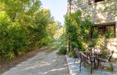 a patio with a table and chairs next to a building at La Casa Di Valcerosa in Apecchio