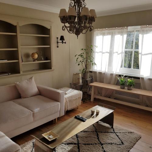 a living room with a couch and a table at Hotel Recour in Poperinge