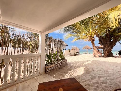 a balcony with a view of the beach at Geo Zanzibar Resort in Jambiani