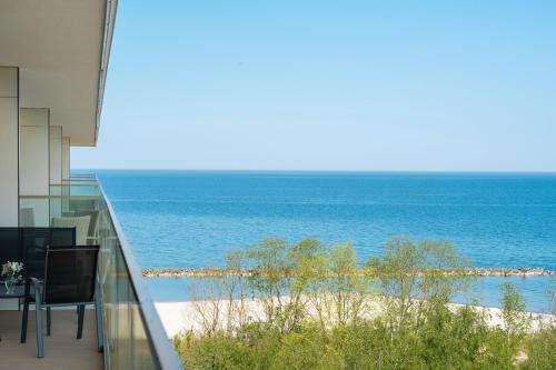 a view of the ocean from the balcony of a building at Apartamenty Solaris in Darłówko