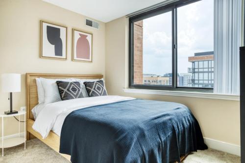 a bedroom with a bed and a large window at Mount Vernon 2BR w WD Gym nr Chinatown WDC-565 in Washington