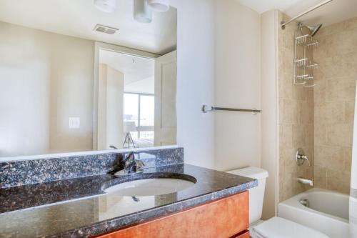 a bathroom with a sink and a tub at Mount Vernon 2BR w WD Gym nr Chinatown WDC-565 in Washington