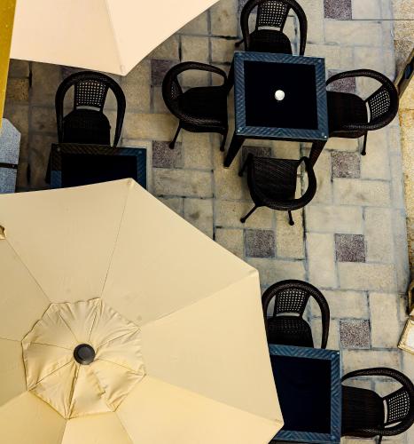 an overhead view of a table and chairs with an umbrella at Bristol Hotel Salalah in Salalah