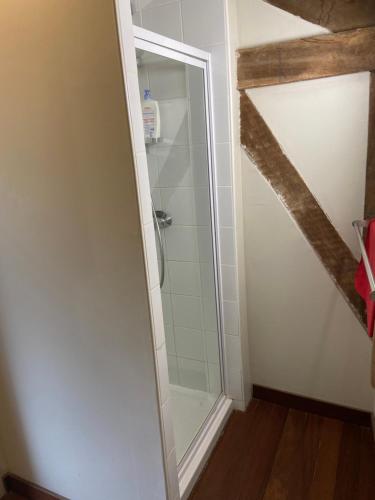 a shower with a glass door in a bathroom at kiné lounge in Bazet