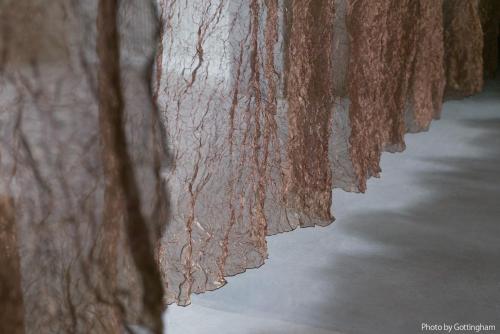 a row of curtains are lined up on a wall at KIRO Hiroshima by THE SHARE HOTELS in Hiroshima
