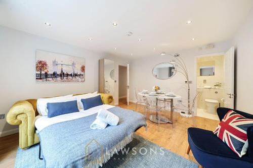 a bedroom with a bed and a table in a room at Stylish Living by Lawsons with 3 Ensuites in Windsor