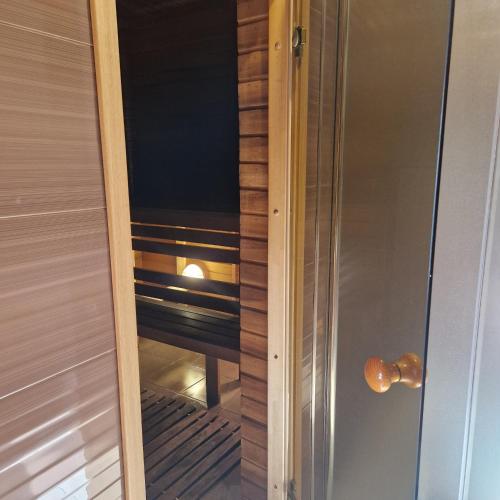 a glass door leading into a walk in closet at Домик с сауной для отдыха in Katase