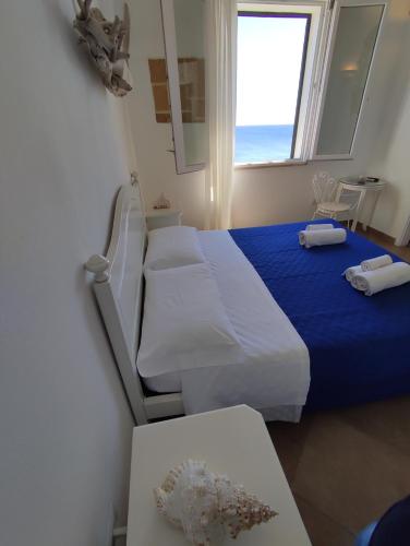 a hotel room with two beds and a window at B&B Punta Cutieri in Gallipoli