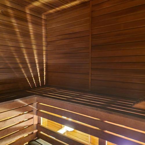 an empty sauna with wooden walls and wooden benches at Домик с сауной для отдыха in Katase