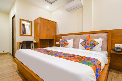 a bedroom with a large bed in a room at FabHotel Atharv in Indore
