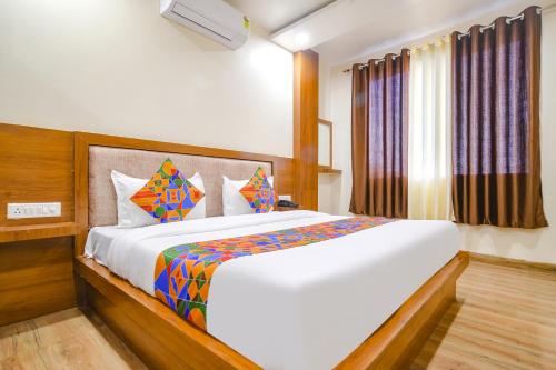 a bedroom with a large bed in a room at FabHotel Atharv in Indore