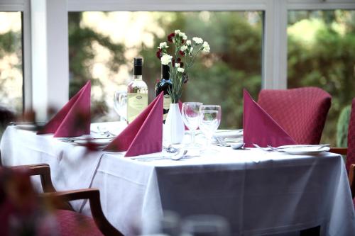 a table with a bottle of wine and wine glasses at Best Western Kings Manor in Edinburgh