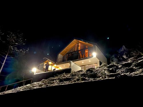 a house on top of a mountain at night at Copanjek Country House in Plešivica