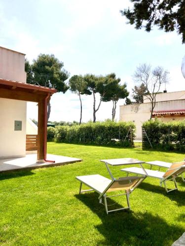 two lounge chairs and a table in a yard at Villa Costanza in Bari