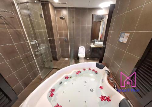 a bathroom with a tub and a shower and a toilet at Gold Coast Morib Resort in Banting