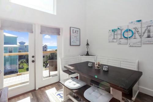 a dining room with a table and a balcony at Eagle's Rest by Pristine Properties Vacation Rentals in Indian Pass