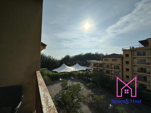 a view from a balcony of a hotel with a pink sign at Gold Coast Morib Resort in Banting