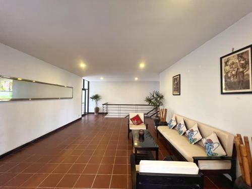 a living room with a couch and a table at The Bliss Angkor in Siem Reap