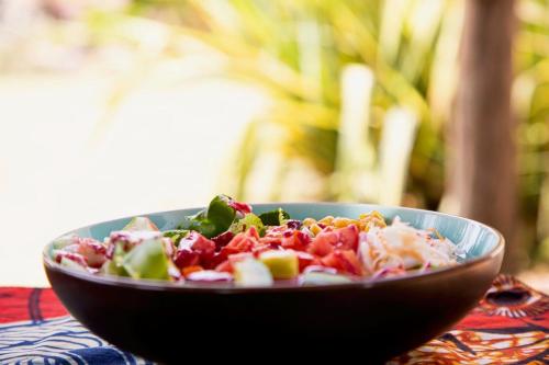 a salad in a bowl on a table at Villa Katwe in Masaka