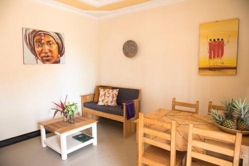 a living room with a couch and a table at Villa Katwe in Masaka