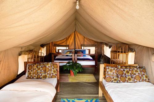 a bedroom with two beds in a tent at Villa Katwe in Masaka
