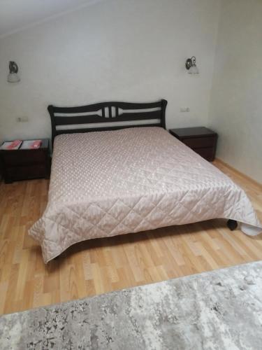 a bedroom with a bed and two night stands at Centralnyi hotel in Poltava