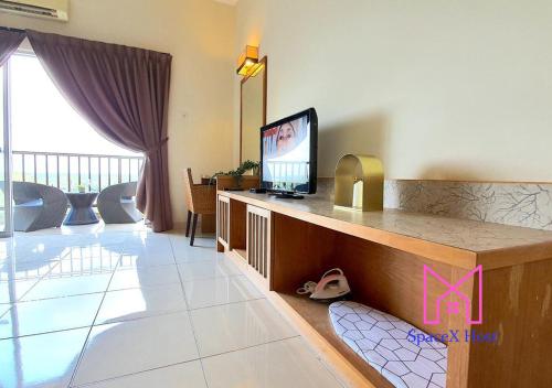 a living room with a flat screen tv on a counter at Gold Coast Morib Resort in Banting